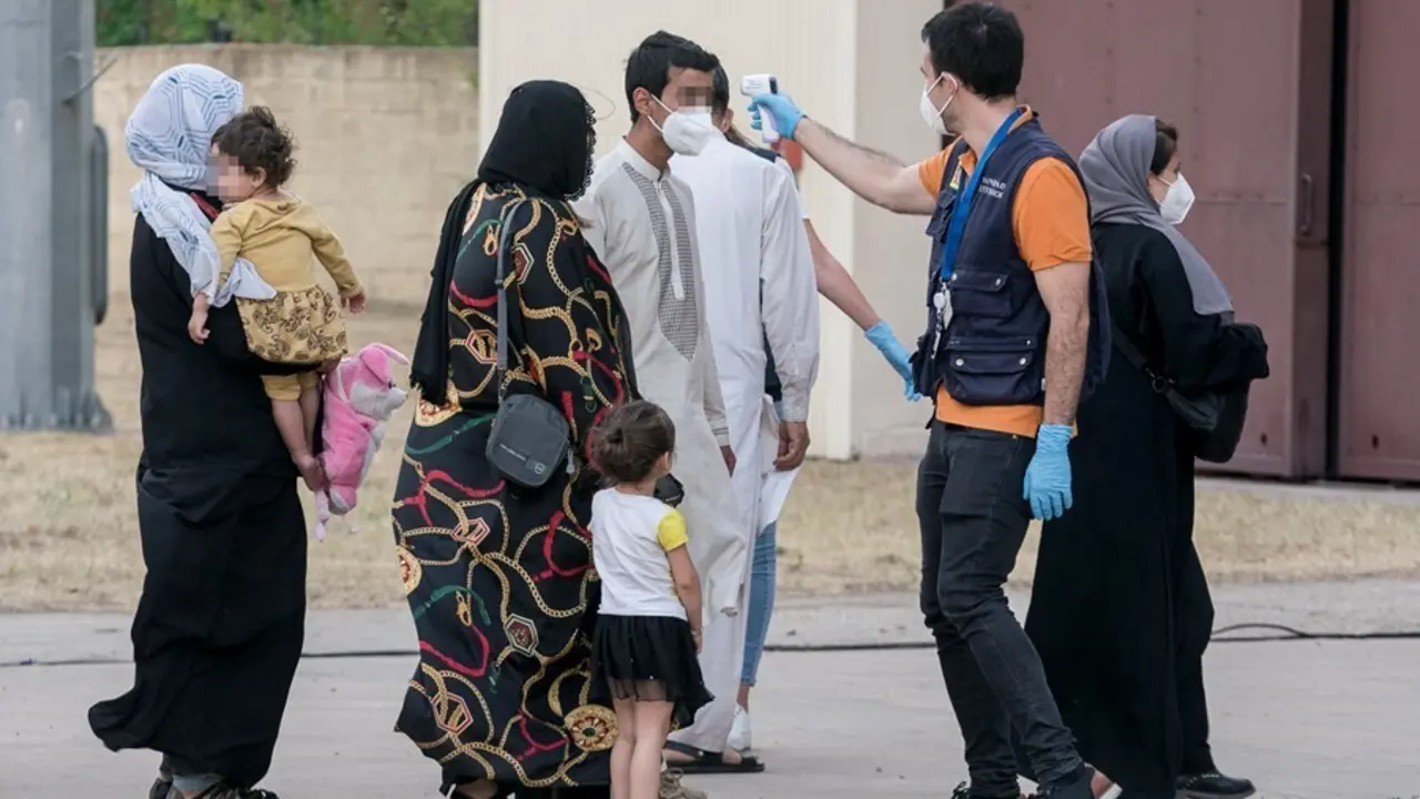 Varios refugiados tras la llegada de un nuevo avi&oacute;n con 260 personas procedentes de Afganist&aacute;n, en la base a&eacute;rea de Torrej&oacute;n de Ardoz.