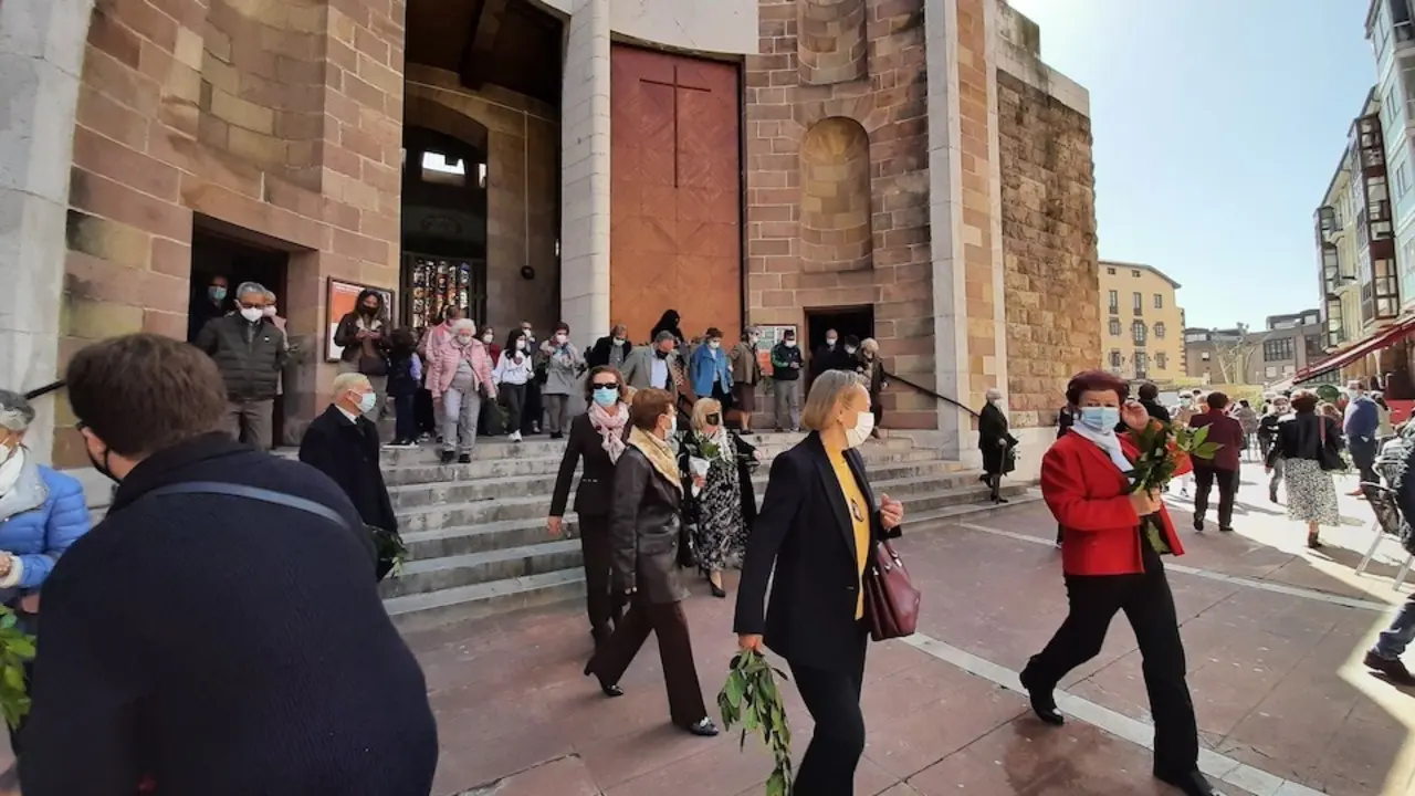 Varias personas salen de la misa del Domingo de Ramos en la Iglesia de Torrelavega. / S. D&iacute;az