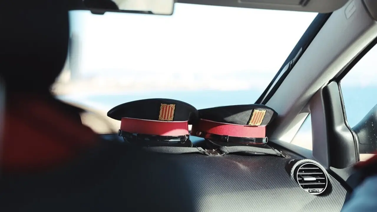 Archivo - Dos gorras en un veh&iacute;culo de Mossos d'Esquadra (ARCHIVO)