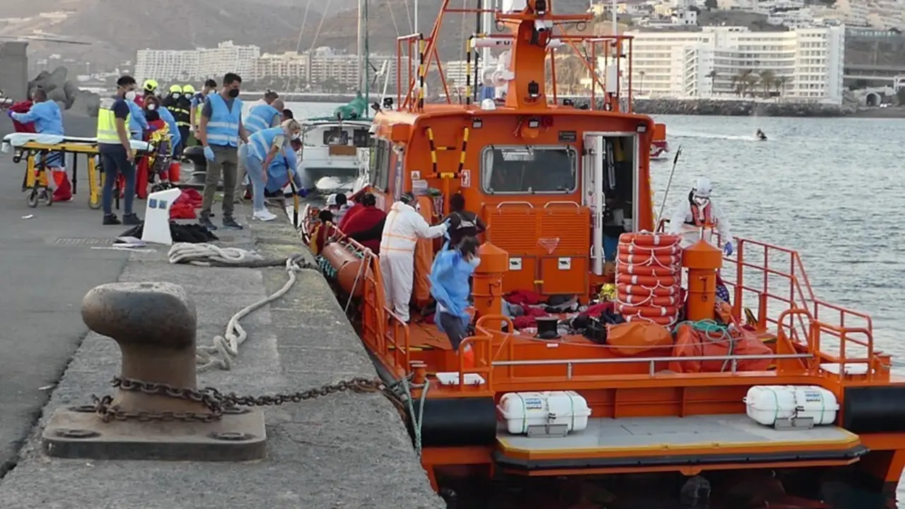 Agentes de salvamento mar&iacute;timo ayudan a un hombre migrante a desembarcar a 26 de agosto de 2021, en Arguinegu&iacute;n (Gran Canaria)