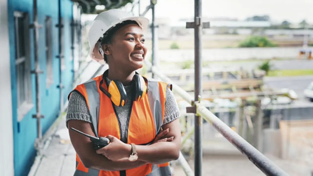 Shot of a young woman working at a construction site