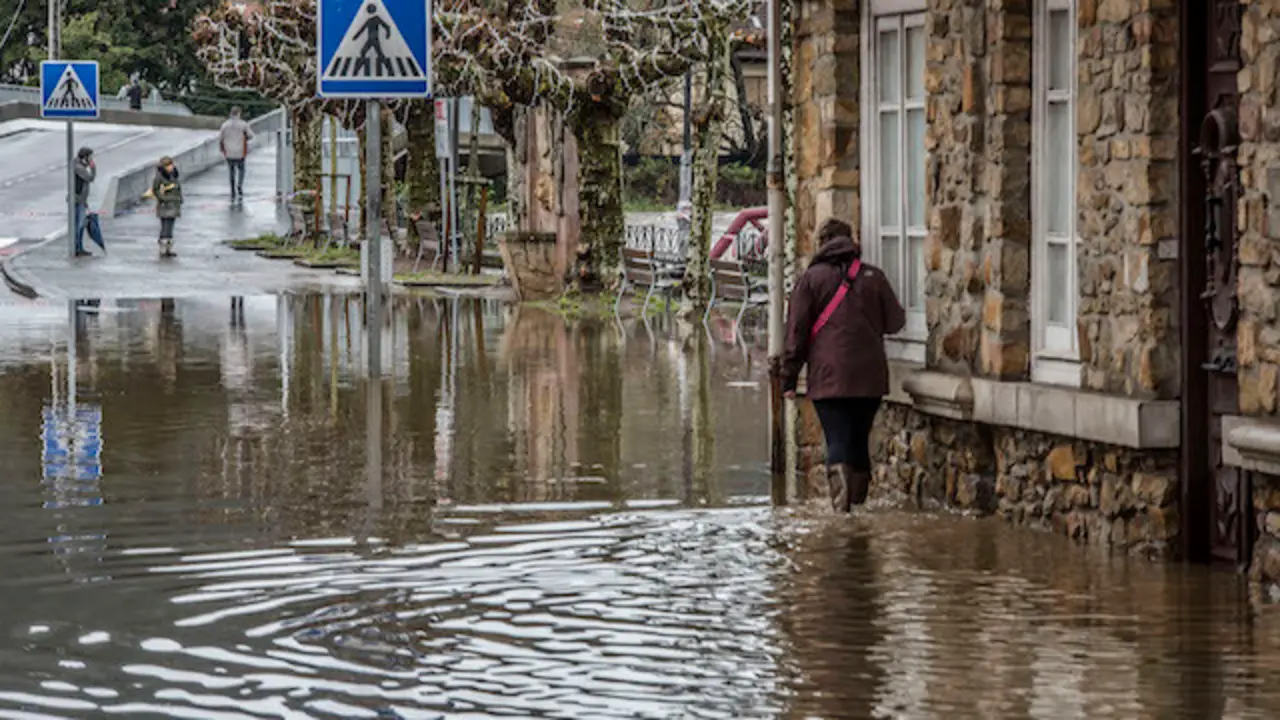 Vecinos, trabajadores de la zona y tractores trabajando en las labores de desag&uuml;e y limpieza de sus establecimientos tras las inundaciones de ayer. / TONO REGUERA