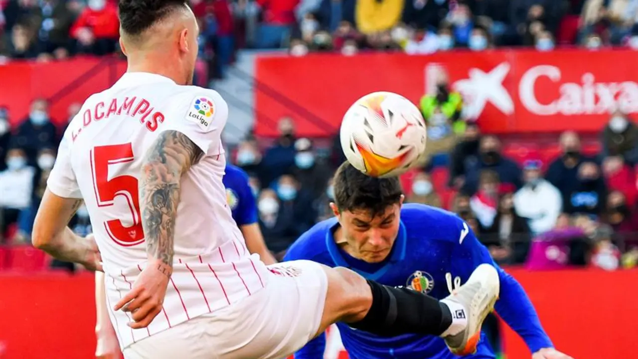 El centrocampista argentino del Sevilla, Lucas Ocampos (i) y el defensa del Getafe, Jorge Cuenca, durante el partido de la vig&eacute;sima jornada de la Liga Santander que se disputa esta tarde en el estadio Ram&oacute;n S&aacute;nchez Pizj&uacute;an de Sevilla. EFE/ Ra&uacute;l Caro.