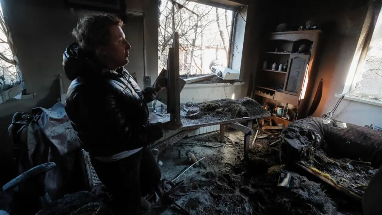 Un hombre recupera objetos del interior de un apartamento da&ntilde;ado tras un bombardeo nocturno en un pueblo de vacaciones en el distrito de Osokorky, en las afueras de Kiev (Ucrania), el 15 de marzo de 2022. EFE/EPA/SERGEY DOLZHENKO
