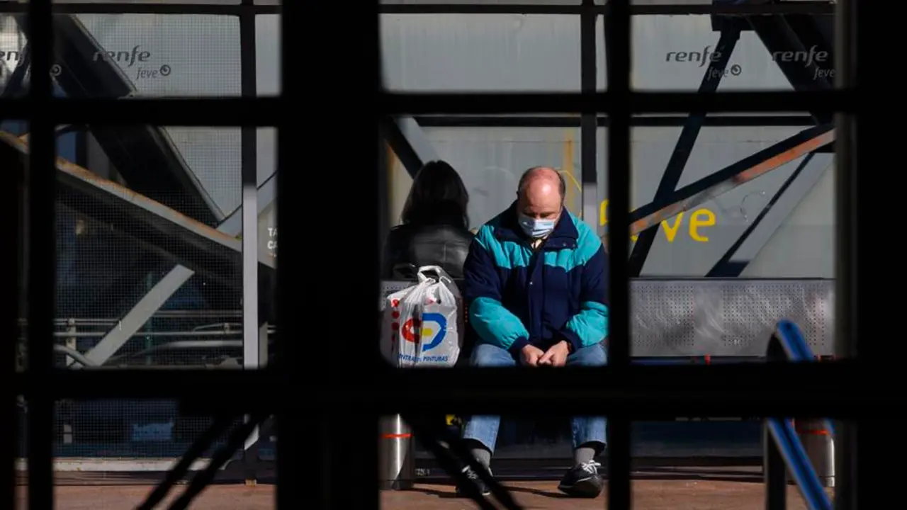 Dos personas esperan en la estaci&oacute;n de trenes de Torrelavega, este martes, en una jornada en que los trenes de Cercan&iacute;as ha estado parados desde la 5:00 hasta las 08:00 por una obras de mantenimiento y acumulan retrasos de 50 minutos. EFE/Pedro Puente Hoyos
