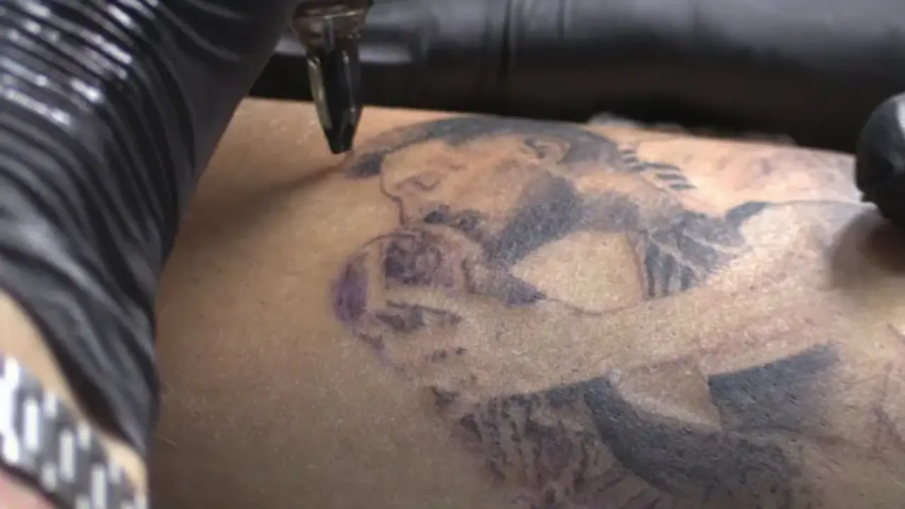Una persona se hace un tatuaje de Lionel Messi besando la Copa del Mundo, el 20 de diciembre de 2022 en Rosario (Argentina). EFE/Rodrigo Garc&iacute;a
