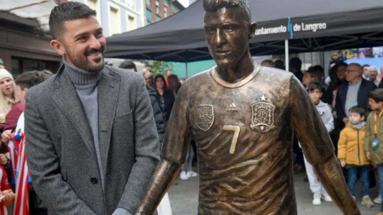 El exfutbolista David Villa observa la estatua en su honor descubierta en La Felguera (Asturias). EFE/ Eloy Alonso
