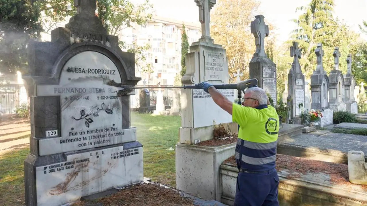 Un operario municipal limpia las pintadas y las manchas con heces en la tumba del socialista asesinado por ETA Fernando Buesa, en el cementerio de Santa Isabel de Vitoria Gasteiz. EFE / Adri&aacute;n Ruiz Hierro
