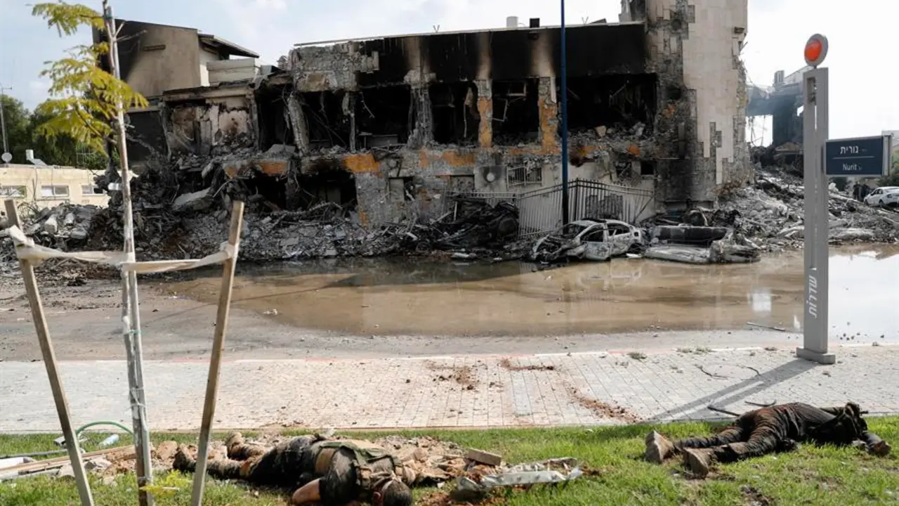 Los cuerpos de militantes de Ham&aacute;s frente a la destruida comisar&iacute;a de polic&iacute;a en la ciudad sure&ntilde;a de Sderot, cerca de la frontera con Gaza. EFE/ ATEF SAFADI
