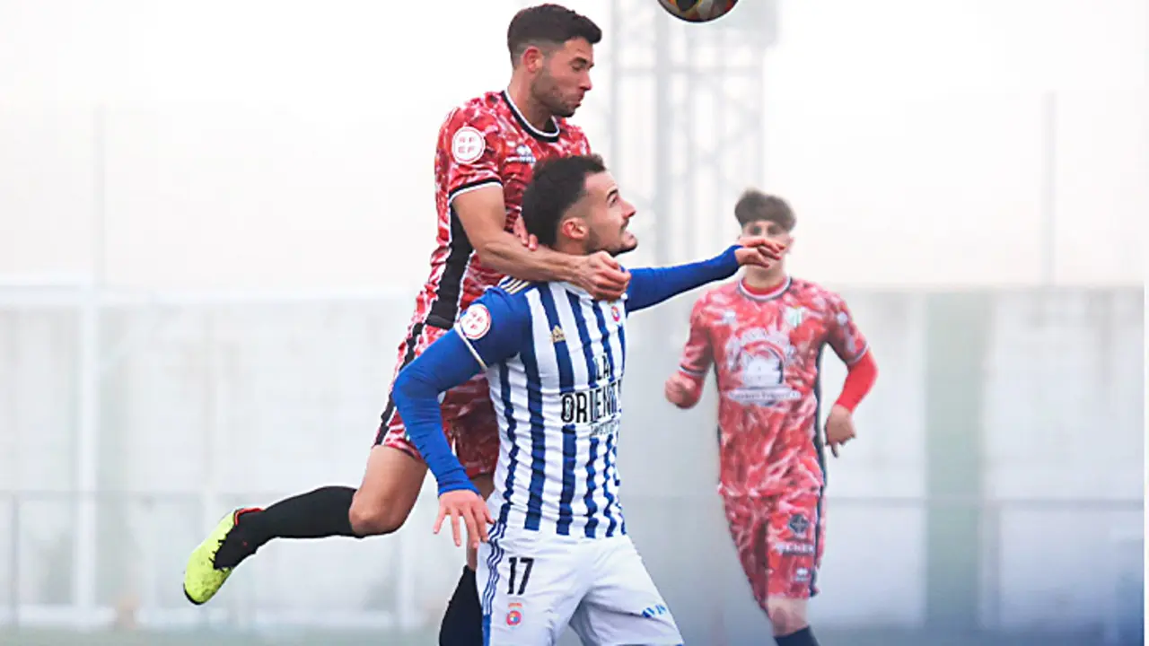 Los jugadores de la Gimn&aacute;stica y Guijuelo disputan un bal&oacute;n a&eacute;reo. / AEE