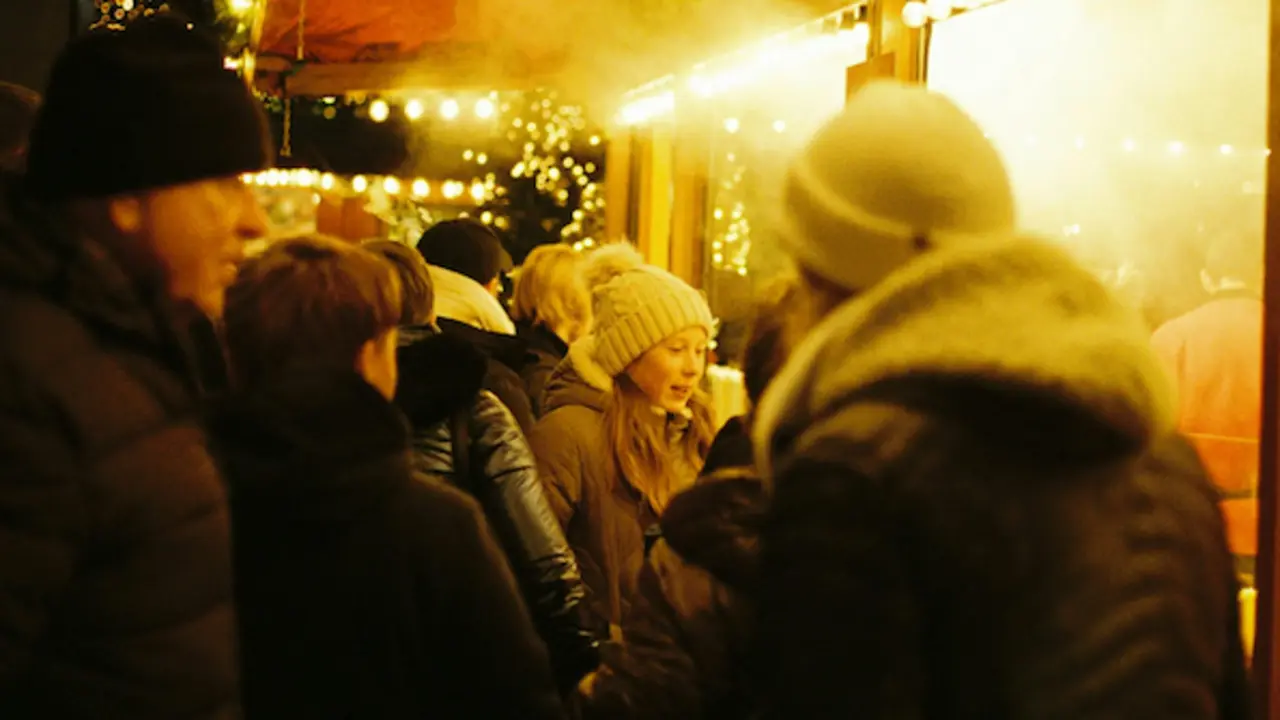Varias personas visitando un mercado de Navidad. / A.E