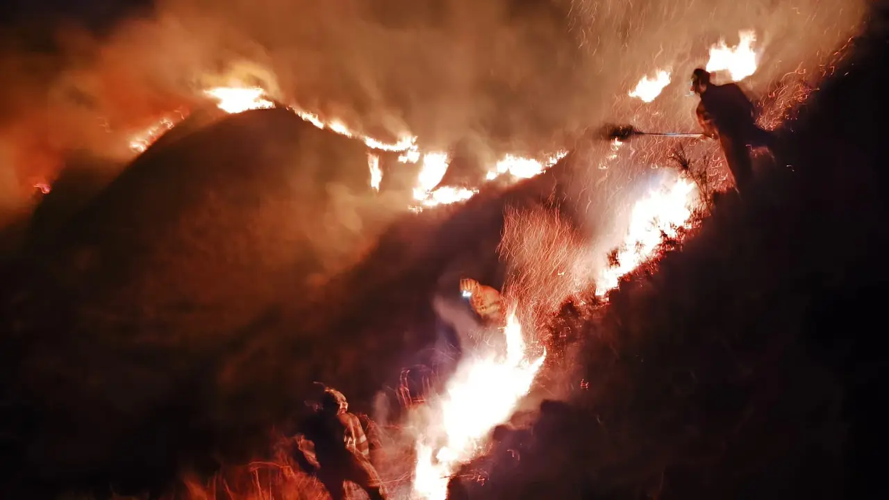 Agentes tratan de acabar con  el fuego. / 112