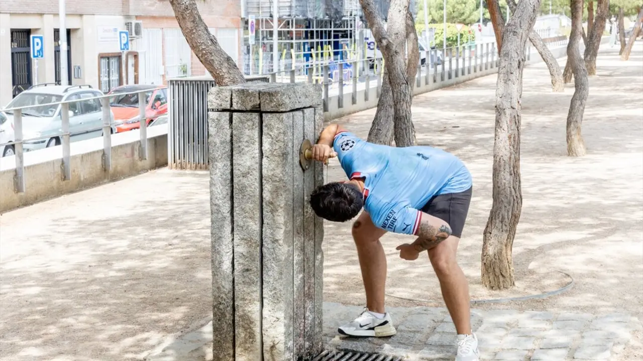 Un chico se moja la cabeza en una fuente debido a las altas temperaturas. / Ricardo Rubio