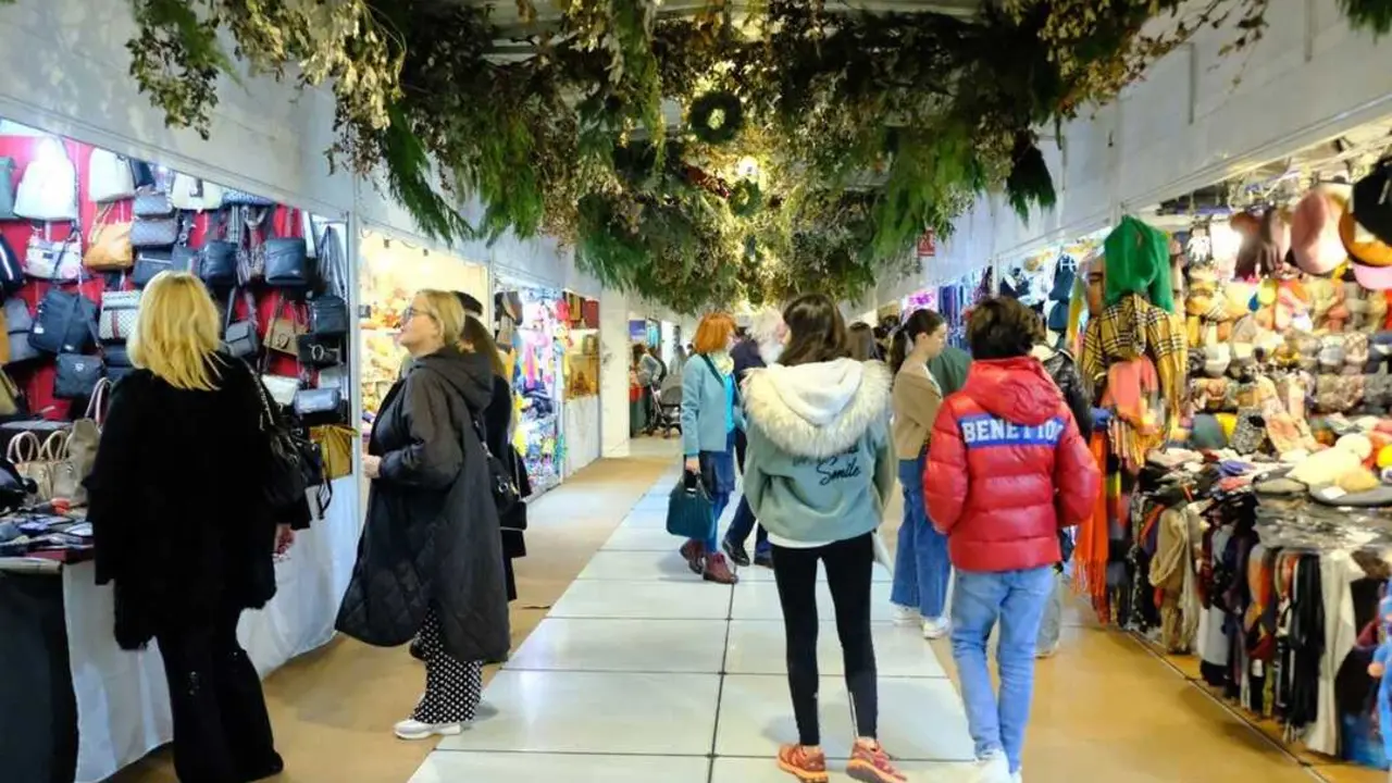 Varias personas caminan por un mercadillo de navidad. / EP
