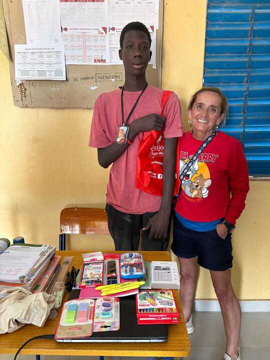 Miriam López junto a uno de los jóvenes becados por Amigos de Louga, durante la entrega de material escolar financiado por la asociación cántabra en Senegal.